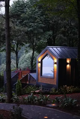 a small house with a window in a garden at Saklı Vadi Tiny House in Masukiye