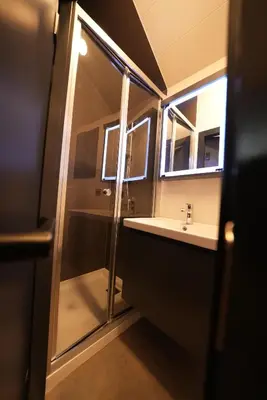 a bathroom with a shower and a sink at Saklı Vadi Tiny House in Masukiye