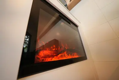 a fire in a window in a room at Saklı Vadi Tiny House in Masukiye