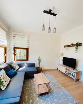a living room with a blue couch and a table at Stylish & Comfort Apartment in Ortaköy in Istanbul