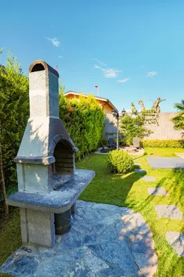 a stone oven in a yard with a grass yard at Resort Mola Sapanca in Sapanca