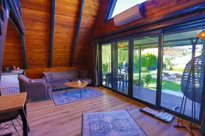 a living room with glass doors and a couch at Resort Mola Sapanca in Sapanca