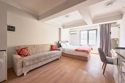 a living room with a couch and a bed at aymira hotel pangaltı in Istanbul