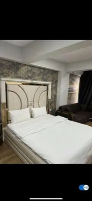 a bedroom with a large white bed and a couch at aymira hotel pangaltı in Istanbul