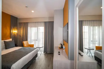 a hotel room with a bed and a television at Icon Hotel Bomonti in Istanbul