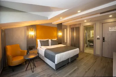 a hotel room with a bed and a chair at Icon Hotel Bomonti in Istanbul