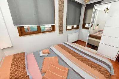 a bedroom with a large bed and a mirror at Taksim Private Terrace Close to Antique Store Galata Port Cihangir in Istanbul