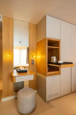 a kitchen with white cabinets and a table at ERK Hotel in Istanbul