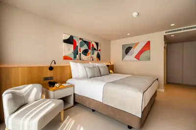 a bedroom with a bed and a chair at ERK Hotel in Istanbul