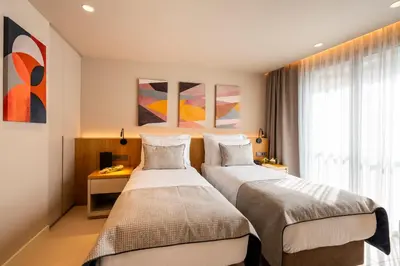 a hotel room with two beds and a window at ERK Hotel in Istanbul