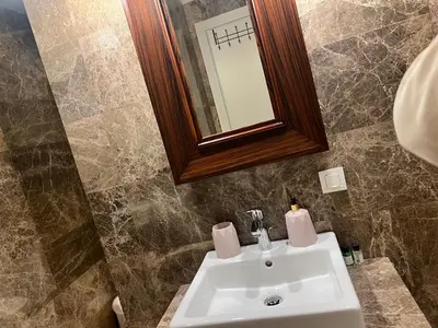 a bathroom with a white sink and a mirror at huzurlu ve şirin in Istanbul