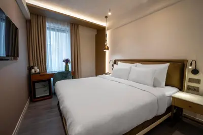 a large white bed in a room with a window at Smart and Simple Hotel Karakoy in Istanbul