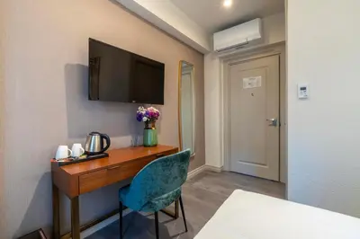 a room with a desk with a television and a chair at Smart and Simple Hotel Karakoy in Istanbul