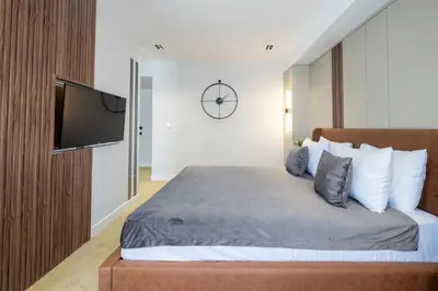 a bedroom with a bed with a tv on a wall at Euphrates Hotel Bursa in İhsaniye