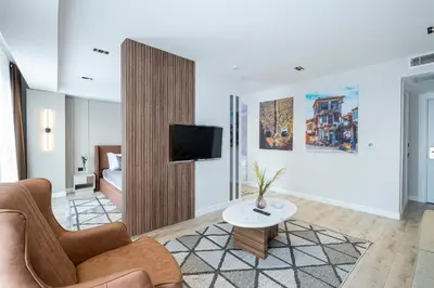 a living room with a couch and a tv at Euphrates Hotel Bursa in İhsaniye