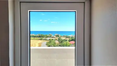 a window with a view of the ocean at Close to IST Airport, Sea view& peaceful apartment in Arnavutköy