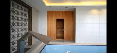 a swimming pool in a building with a hallway at Blue Resort in Ovaakçaköy