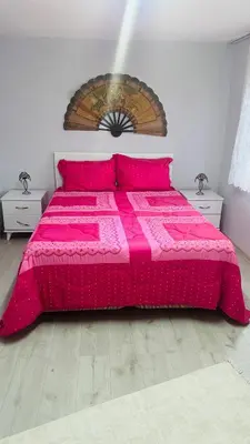 a bedroom with a pink bed with two night stands at Farm Village in Sakarya