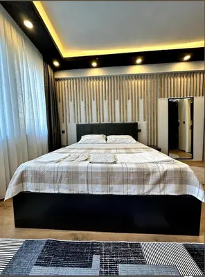 a bedroom with a large bed with a striped blanket at The Port Palace Hotel in Istanbul