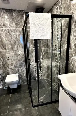 a bathroom with a shower and a toilet and a sink at The Port Palace Hotel in Istanbul