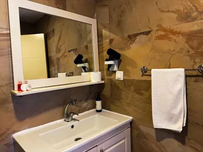 a bathroom with a sink and a mirror at Yalı Bahçe Mudanya in Burgaz