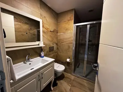 a bathroom with a toilet and a sink and a shower at Yalı Bahçe Mudanya in Burgaz