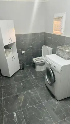 a bathroom with a washing machine and a toilet at Farm Village in Sakarya