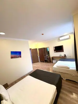 a bedroom with two beds and a living room at Grand Ararat Hotel in Istanbul