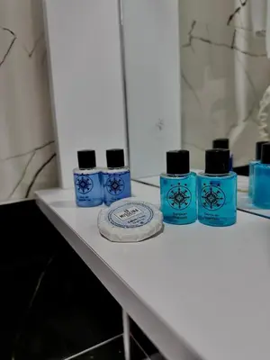 four blue bottles of soap sitting on a counter at Grand Ararat Hotel in Istanbul