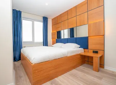 a bedroom with a bed with a wooden headboard at Guest Suites in Istanbul