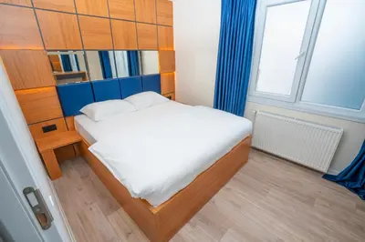a small bedroom with a bed and a window at Guest Suites in Istanbul