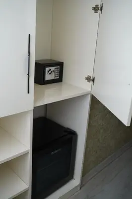 a kitchen with a white cabinet with a black toaster at Sword Suit Hotel in Istanbul