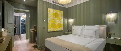 a bedroom with a large bed with white pillows at Komana Hotel Binbirdirek in Istanbul