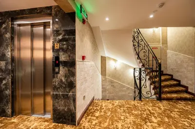 a lobby with a metal elevator and a staircase at Old Harbour Hotel istanbul in Istanbul