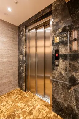 a elevator in a lobby with a marble wall at Old Harbour Hotel istanbul in Istanbul