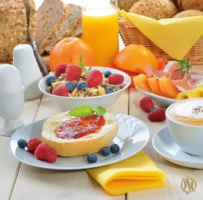 a table topped with plates of breakfast foods and fruit at Hotel Suadiye in Istanbul