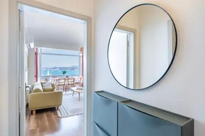 a mirror on a wall next to a living room at Stay Beyond the Bosphorus #5 in Istanbul