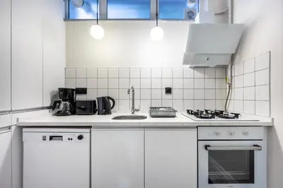 a kitchen with white cabinets and a stove top oven at Stay Beyond the Bosphorus #5 in Istanbul