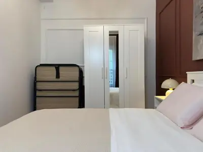 a bedroom with a white bed and a mirror at Historic High-Ceiling 2-Flat Combo - Taksim in Istanbul