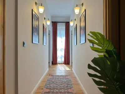 a hallway with white walls and a rug on the floor at Historic High-Ceiling 2-Flat Combo - Taksim in Istanbul