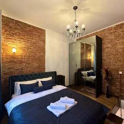 a bedroom with a large bed with towels on it at Beyoğlu'nda dubleks tarihi daire in Istanbul