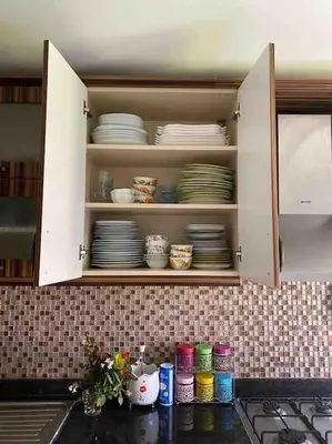 a kitchen cabinet with plates and dishes in it at Tuzlada Ferah Alani Havuz,Bahçe ve tüm rahatlıklar kişiye özel alan in Tuzla