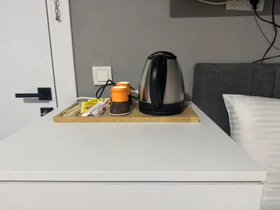 a coffee maker sitting on a wooden tray on a bed at Old City Kadıköy Otel in Istanbul