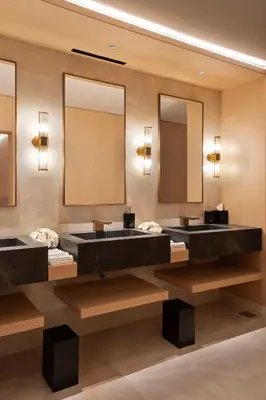 two sinks in a bathroom with two mirrors at Vakko Hotel Sumahan Bosphorus in Istanbul