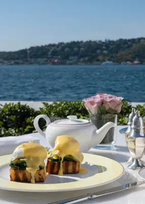 a table with a plate of food and a cup of tea at Vakko Hotel Sumahan Bosphorus in Istanbul