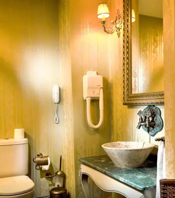 a bathroom with a sink and a toilet and a mirror at Anemon Bursa Gönlüferah Termal&Spa Otel in Bursa