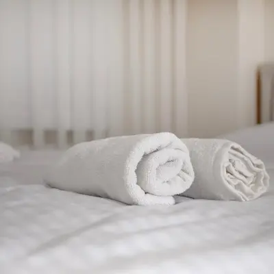 a rolled up towel on top of a bed at New furniture, zero air conditioning, modern and quiet 19 in Istanbul