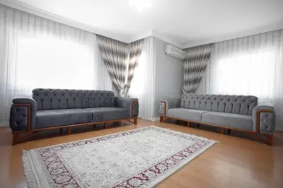 a living room with two couches and a rug at Large central apartment in a quiet area 40 in Istanbul