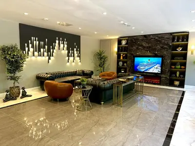 a living room with a couch and a tv at Kerpe Bungalov Hotel in Kandıra
