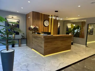 a lobby with a reception desk and a clock at Kerpe Bungalov Hotel in Kandıra